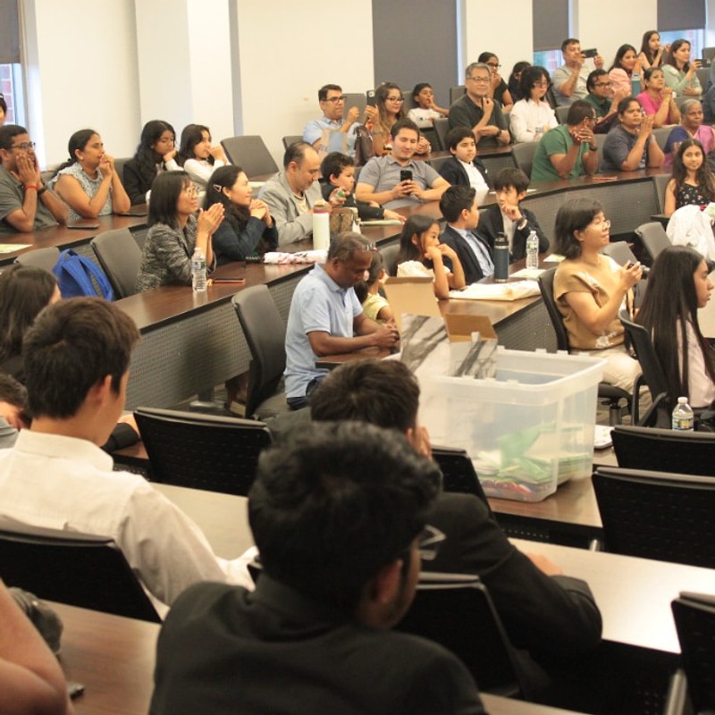 Audience seated in the lecture hall during Green Dream presentations