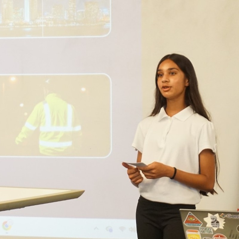 Student presenting a safety and sustainability project at the podium