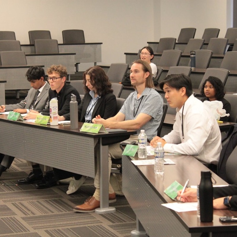 Judges panel seated at the front table during presentations