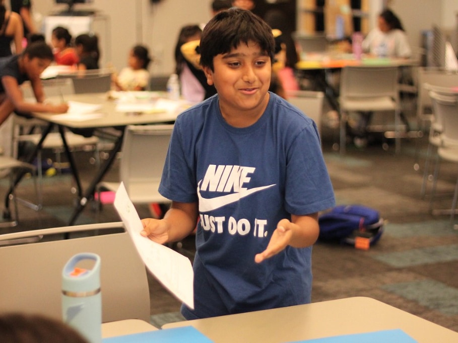 Student presenting a sustainability project on paper during Green Dream Challenge