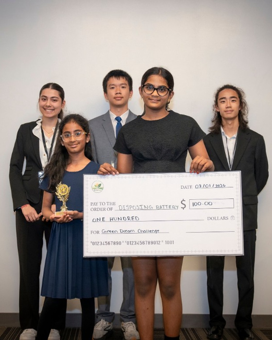 Vikashni Selvaraj, Kayal Prabhu, and Kavinaya Sureshkumar with the Discarding Batteries fourth-place trophy and $100 prize check