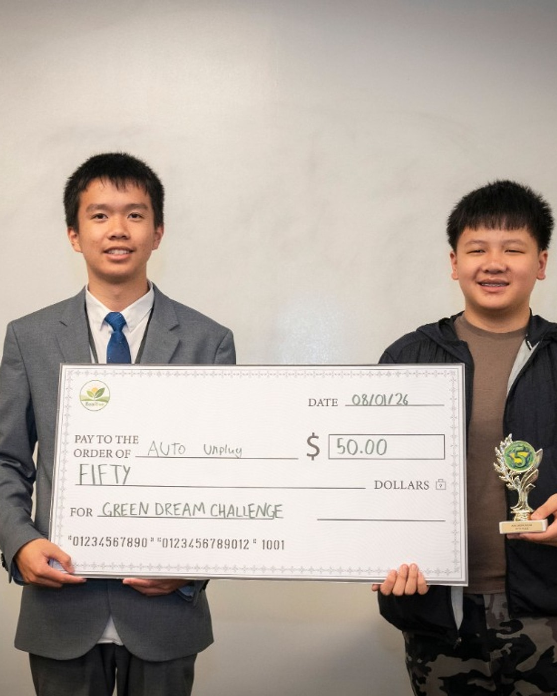Michael Nie holding the Auto Unplug fifth-place trophy and $50 prize check
