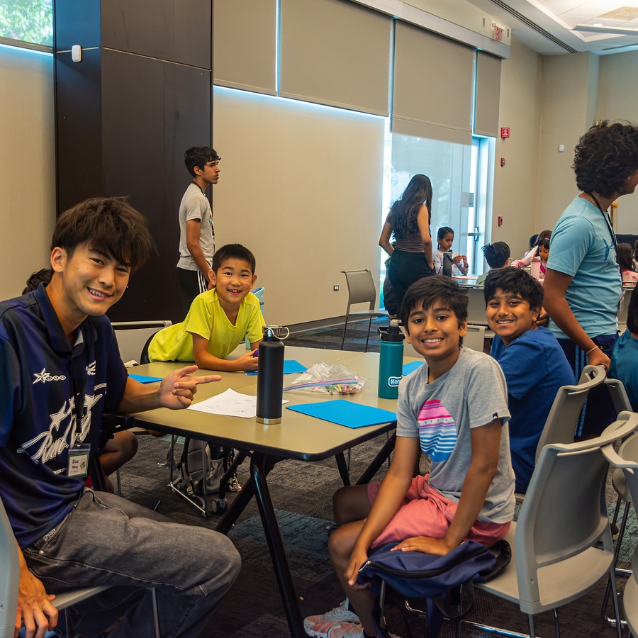 EcoRise students smiling together at a workshop table