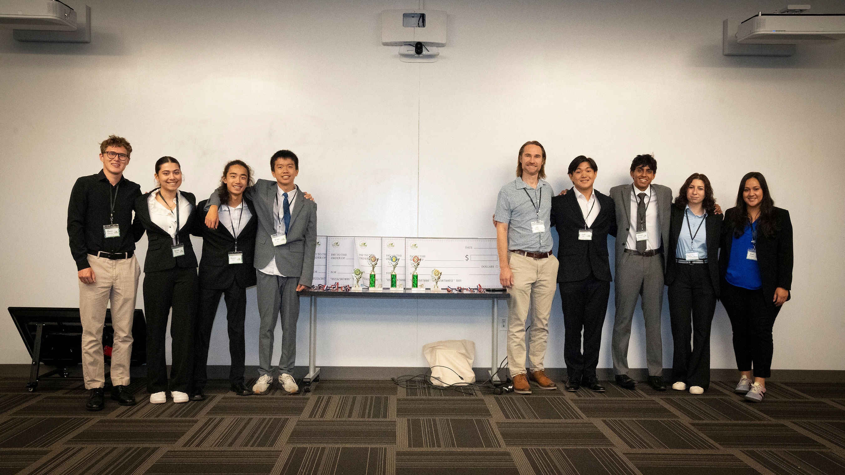 Green Dream Challenge winners and organizers posing with trophies and prize checks