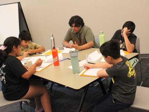 EcoRise camp mentor guiding students during a session