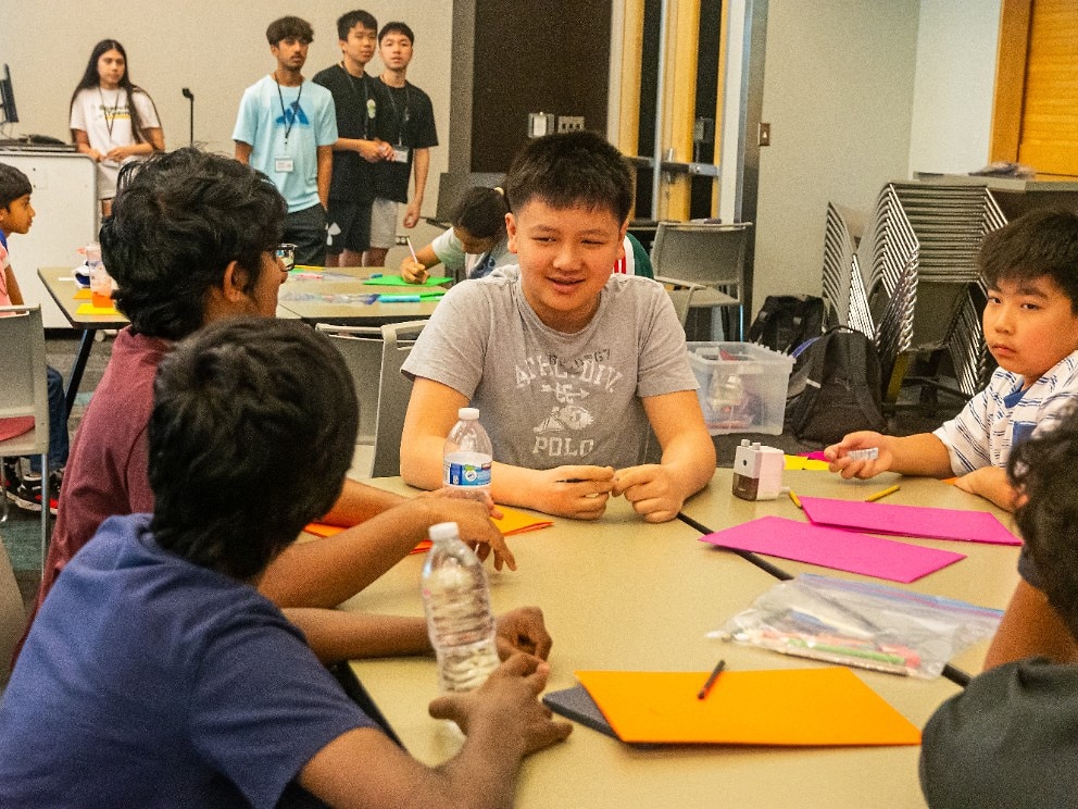 Students collaborating on a sustainability activity during EcoRise camp