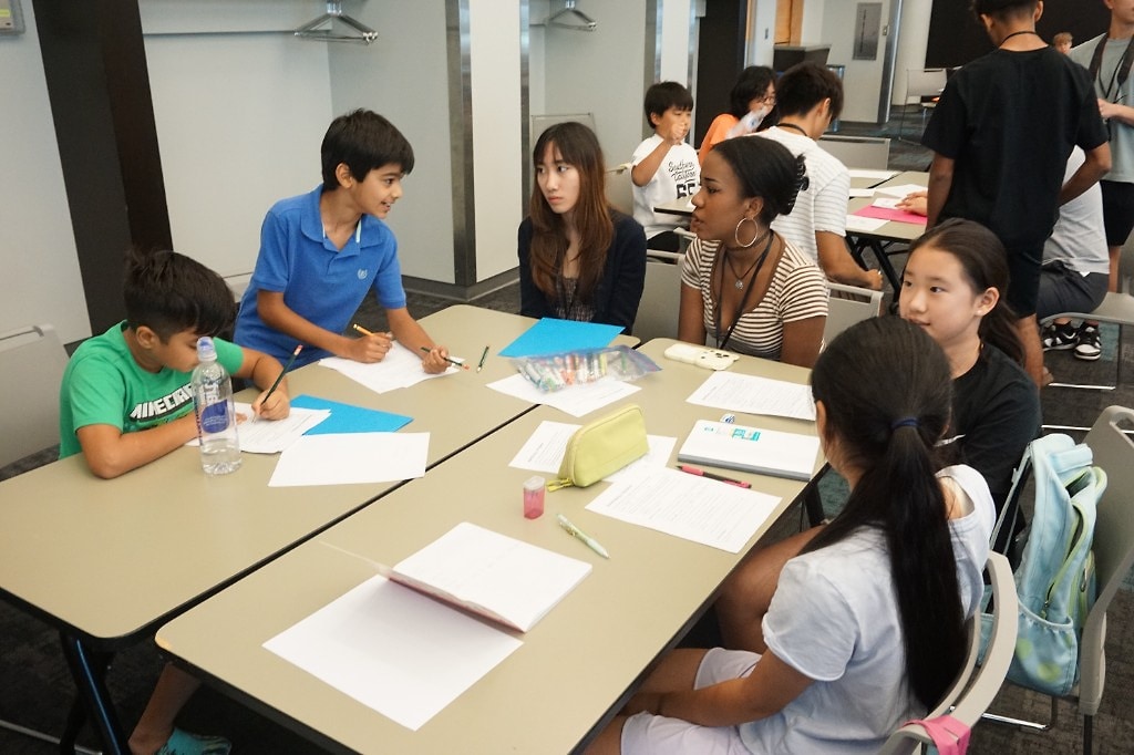 Students and instructors collaborating during a renewable energy workshop