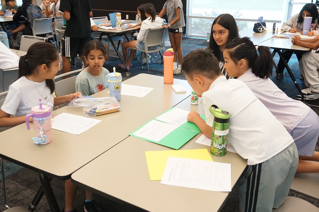 Students collaborating on a Developing a Solution project during EcoRise camp